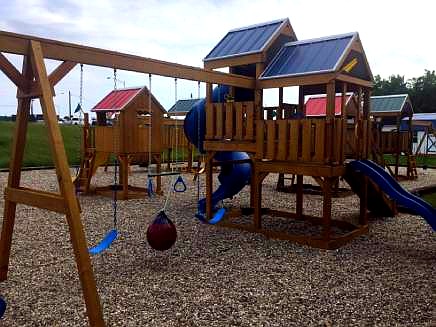 Wooden playground with swings and slides