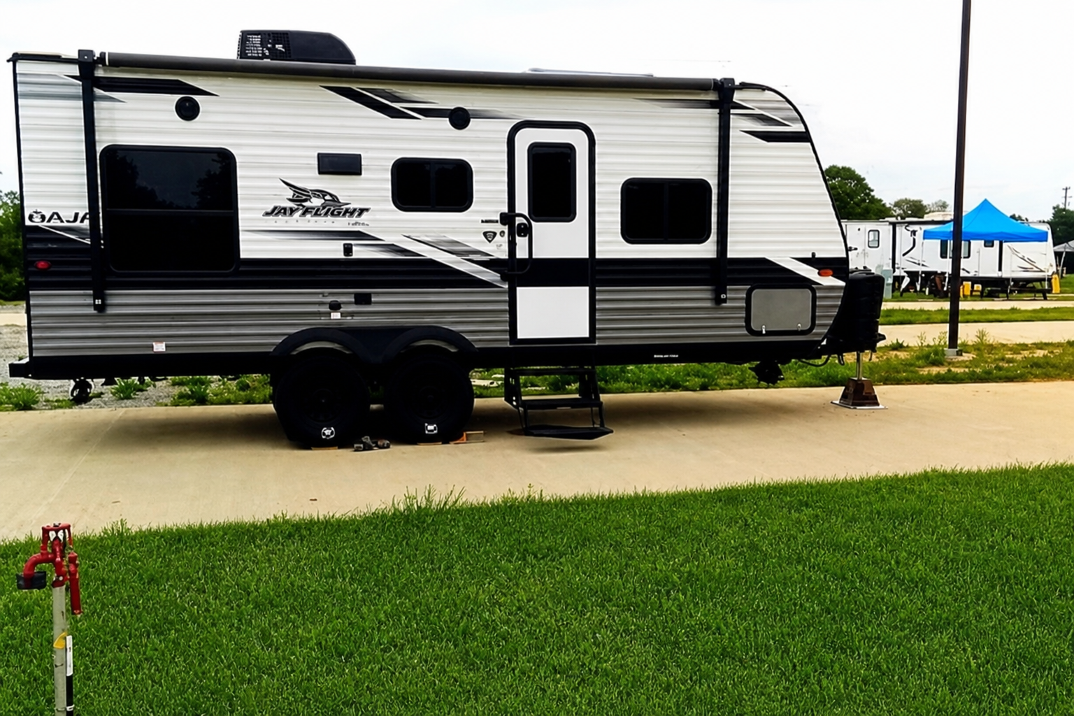 RV on concrete pad with water and electric hookup
